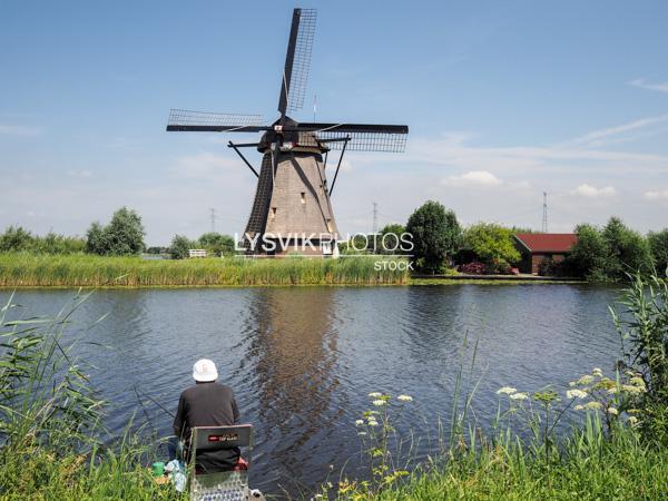 Visser met molen bij Kinderdijk [00976577]